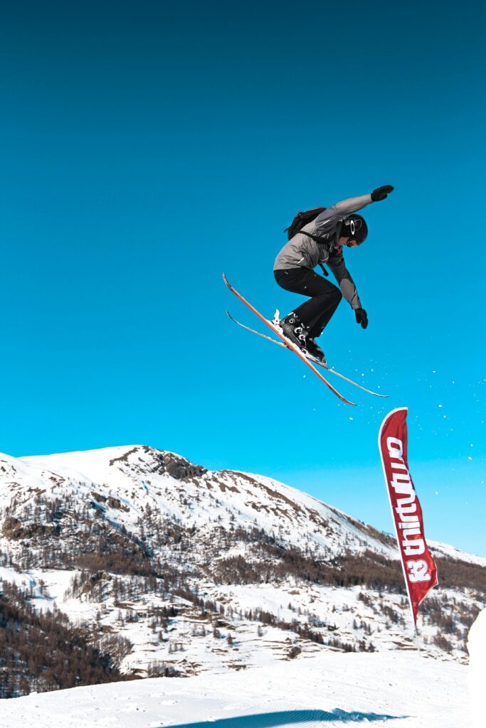 pexels-photo-2433356-2433356 High-energy capture of a skier mid-jump against a stunning mountain backdrop.