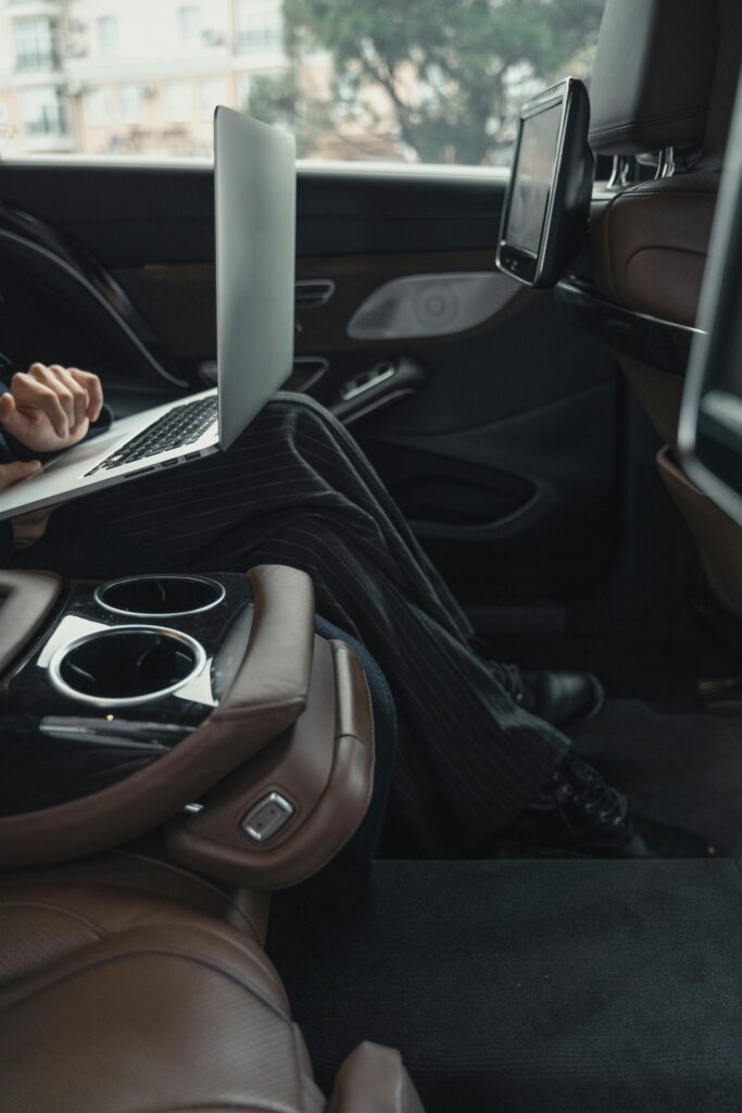 pexels-photo-5717640-5717640 A professional woman working remotely on a laptop inside a luxurious car. Modern executive lifestyle.