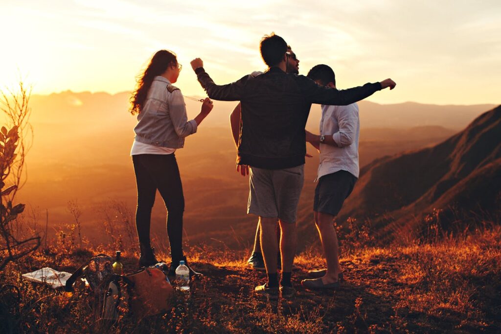 pexels-photo-697244 Joyful group of young adults enjoying a sunset view in a mountainous landscape in Brazil.